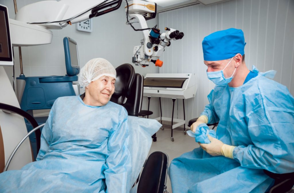 An ophthalmic surgeon prepares for cataract surgery with an older patient