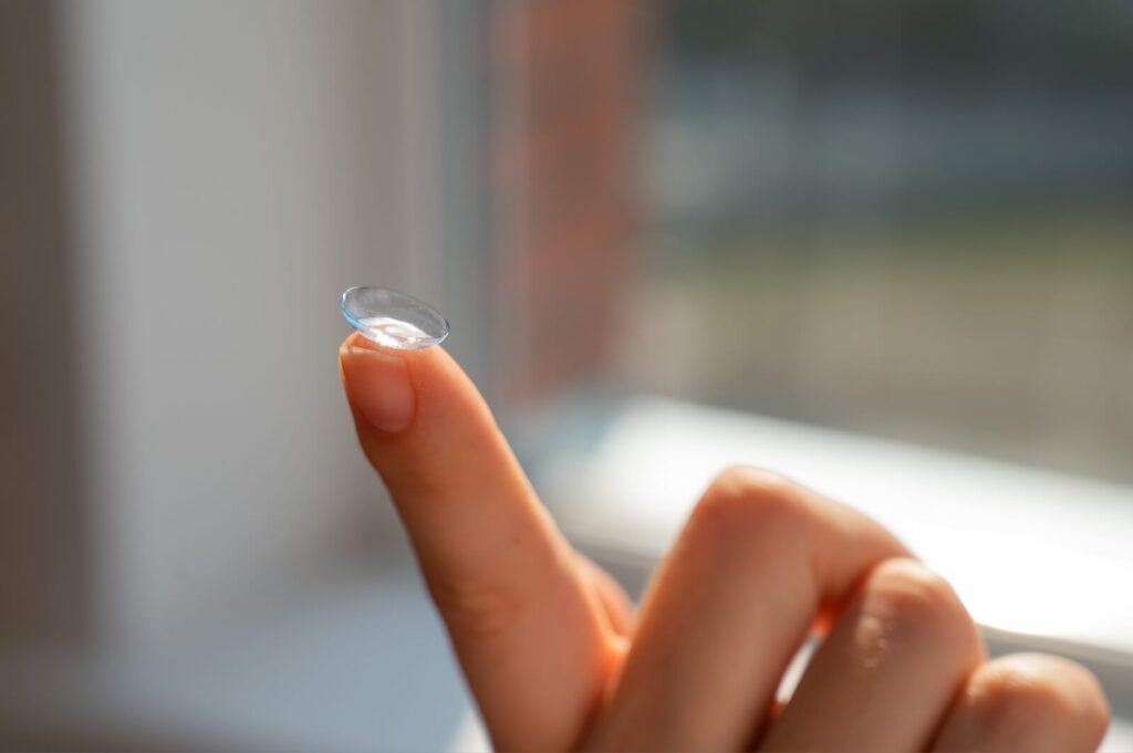 Close-up of a contact lens on a woman's index finger.